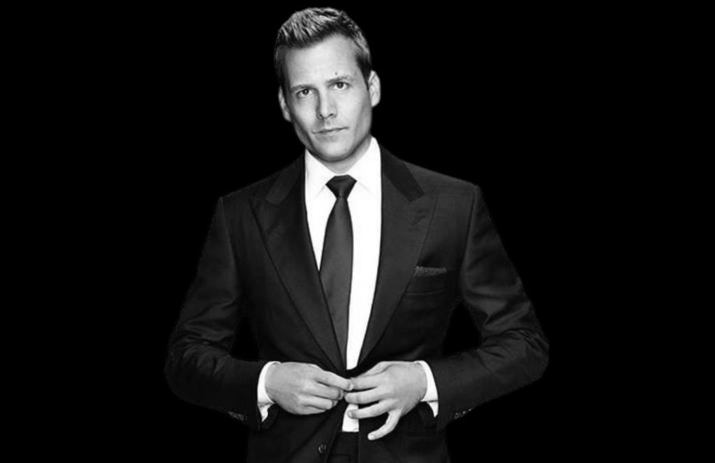 Harvey Specter has a stern body language and tone